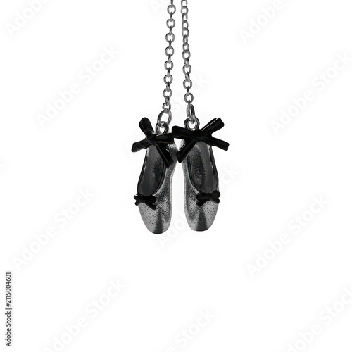 Delicate silver sparkly ballet slippers with black bows hanging from chains