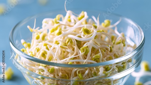 Fresh Bean Sprouts in a Clear Glass Bowl on a Blue Background Perfect for Healthy Eating and Culinary Inspiration in Stock Photography