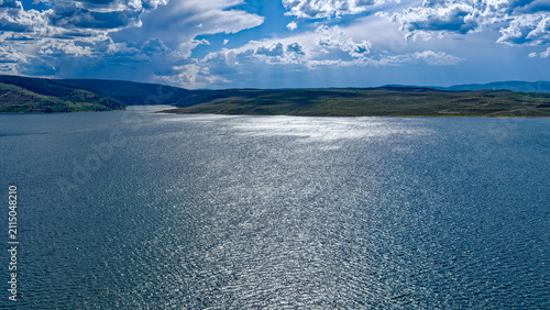 Panorama of the glint of sunlight shining over the waters of the Strawberry Reservoir east of Heber City, Utah, USA