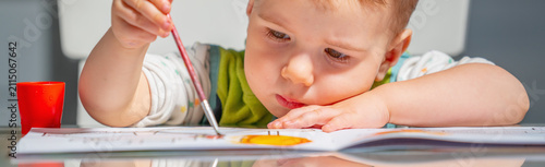 Young child enjoying a relaxing indoor arts and crafts session.