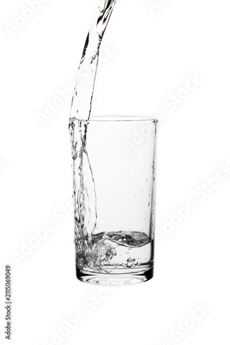 Photography Pouring fresh drinking water into a clear glass isolated on a white background