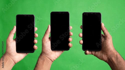 Three modern smartphones rising into view. Generic mobile devices appearing on screen.