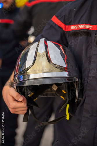 Quadro su tela French firefighter holding a protective helmet during an emergency response