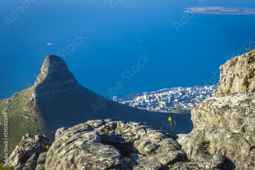 Aerial view of Lion's Head peak, the Camps Bay coastline and Robben Island from the summit of Table Mountain at golden hour, Cape Town, South Africa