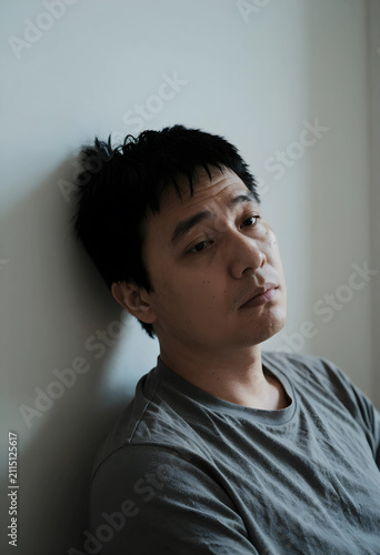 Asian man with a serious ex...