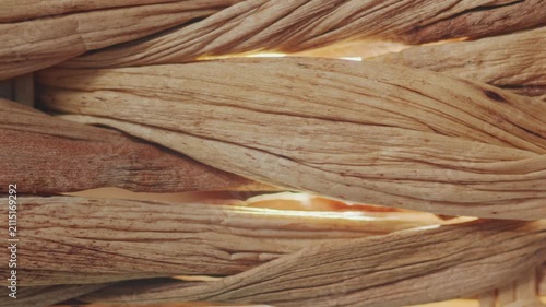 Close-up of woven water hyacinth fibers. The camera captures the intricate depth and shadows of the braided material