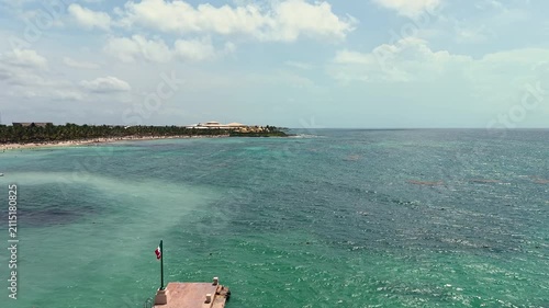 Aerial view of Caribbean sea ,sandy beach, pier with docked boat and palm trees in Playa del Carmen, Cancun, Mexico