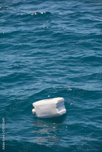 Canvas Print A white plastic jerrycan floats adrift on the deep blue sea, illustrating global environmental issues regarding marine debris