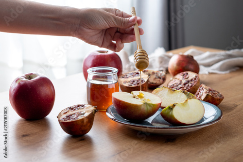 Rosh Hashanah apples and honey with pomegranate on table