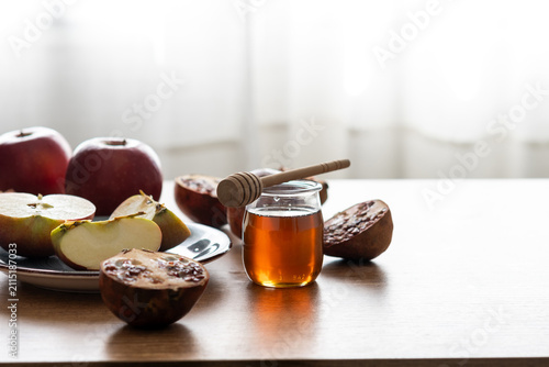 Rosh Hashanah table with apple, honey, and pomegranate