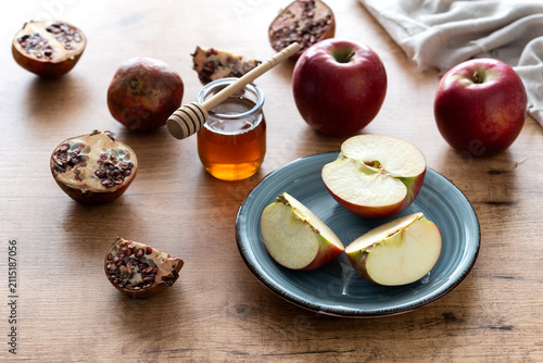 Rosh Hashanah apples, honey and pomegranate on table