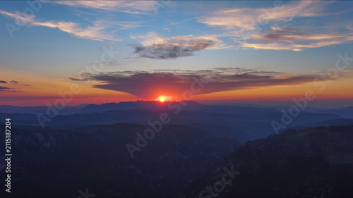 Plakat Sun setting over mountain and evening sky