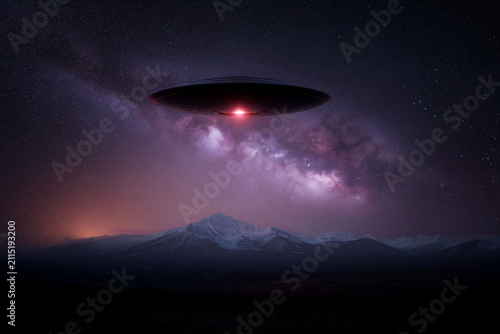 Futuristic alien ufo spaceship flying over snowy mountain peaks under starry milky way night sky