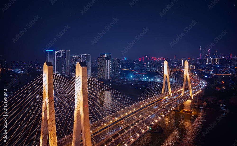 Fototapeta premium Aerial top night view of Guangzhou, illuminated urban landscape and modern bridge in Guangdong China