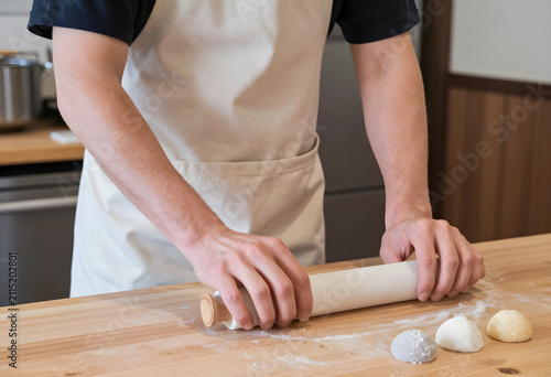 Chefs hands rolling mochi d...