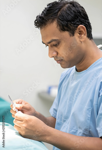 Indian male surgeon in blue...