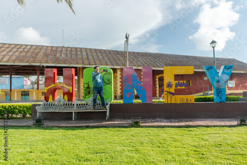 Traveler taking selfie at colorful honey city letters in puebla mexico