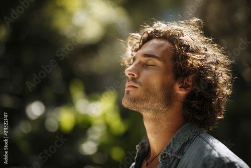 Calm moment: a man breathing deeply in a sunlit park