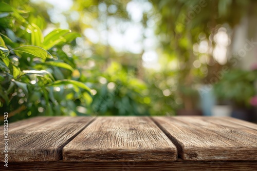 Outdoor wooden table in a vibrant green yard, gentle background blur for advertising design