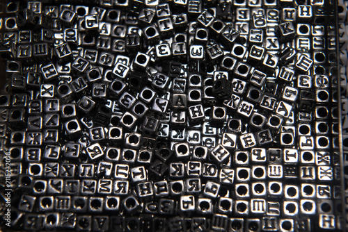 Black and white photo of beads with cyrillic letters