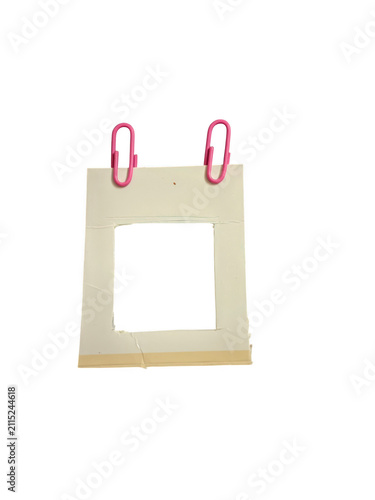 Blank paper frame held by two pink paper clips