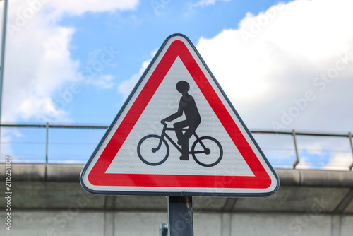 Bicycle warning traffic sign against blue sky