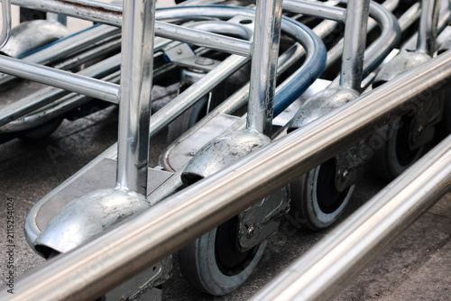 Close up of airport luggage trolley wheels and metal frame