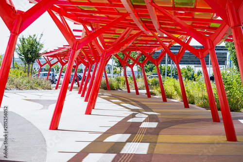 Modern red metallic structures with colorful glass against the blue sky