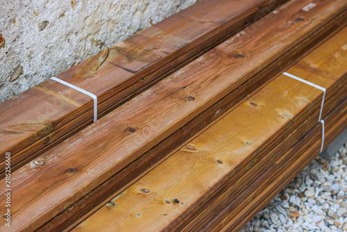 Stack of brown wooden planks, floor construction planks