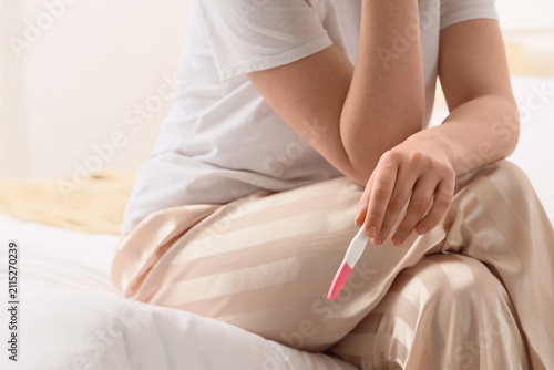 Woman with pregnancy test s...