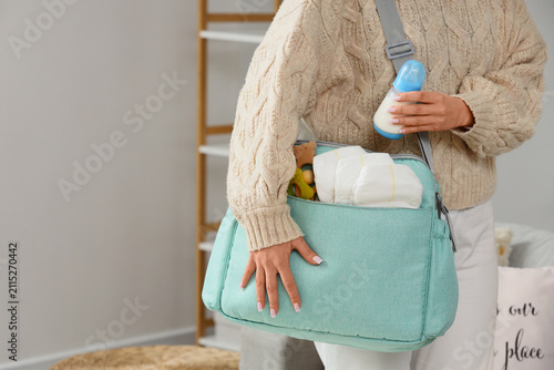 Woman with baby bag and bot...