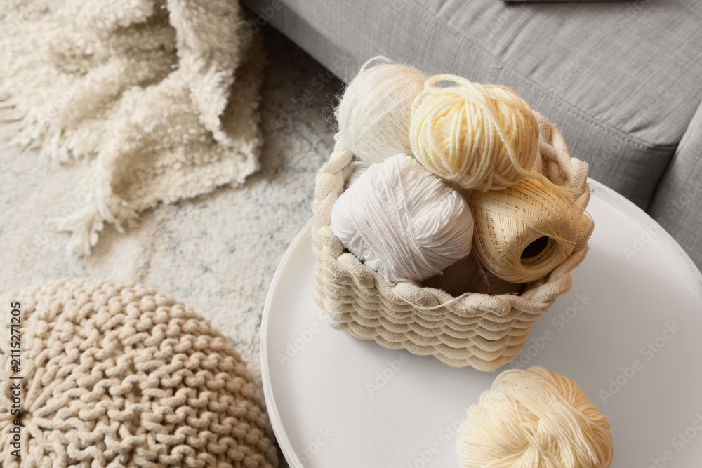 Obraz premium Basket with knitting yarn on table in living room, top view