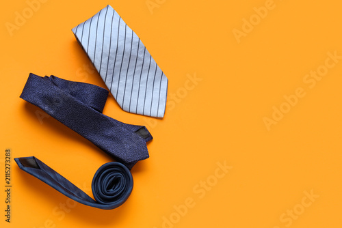 Stylish male ties on orange...