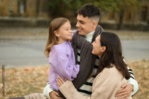 Happy family hugging in bea...