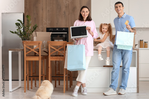 Happy family with laptop an...