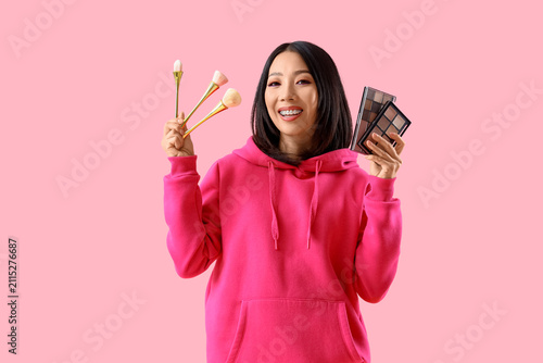 Young Asian woman in hoodie...