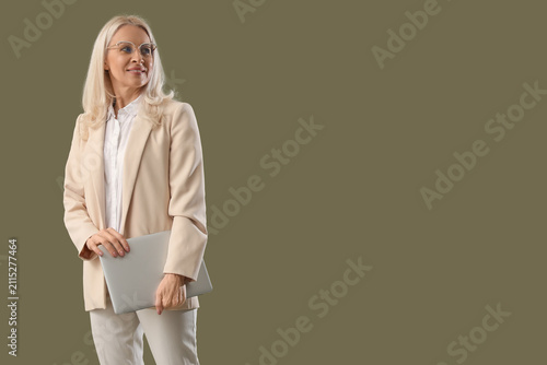Mature woman with laptop on...