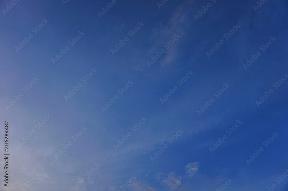 Fototapeta premium Vibrant Blue Sky with Wispy Clouds on a Clear Day.