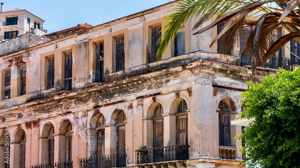 Obraz premium Vathy, Greece - July 25, 2026: View of a house in Vathy on Samos Island, Greece, showing local residential architecture, simple facade, windows, and peaceful Greek island town atmosphere.
