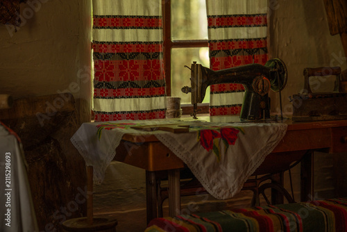 Vintage sewing machine in a cozy room with colorful curtains during the day