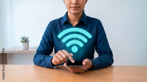 Businesswoman using smartphone with wifi symbol at office desk. Wireless internet, connection and network