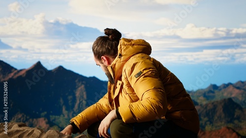 Obraz na płótnie A distracted mountain hiker drops his smartphone through poor attention in risky high-altitude wilderness, showing technology obsession and reckless behavior
