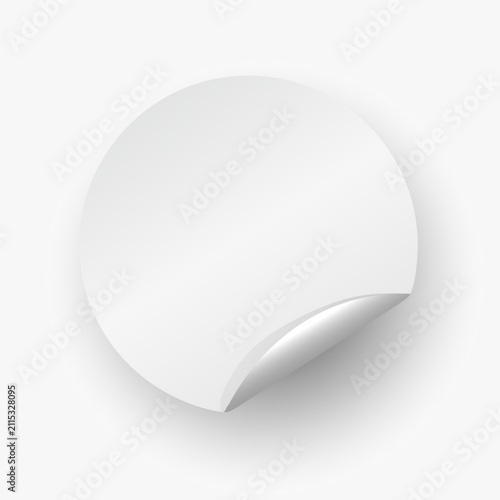 A realistic template of a blank white circular sticker or label with a slightly peeled and curled bottom corner. 