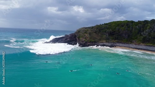 Surfers riding waves along the Noosa coastline