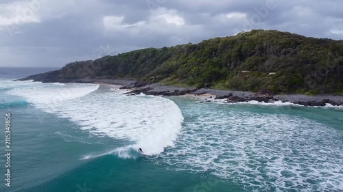 Surfers near the forested coast of Noosa Queensland