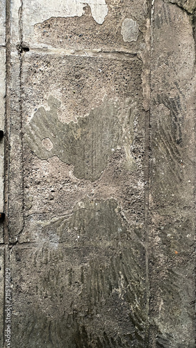 Old deteriorated concrete wall with peeling cement, rough surface, and exposed texture. Suitable for grunge backgrounds, construction themes, and architectural design.