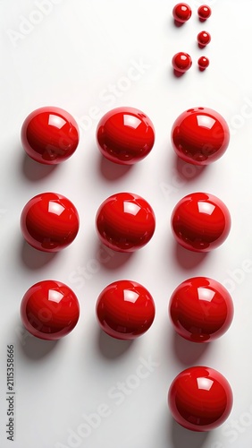 Twelve glossy red spheres arranged in rows with smaller spheres above