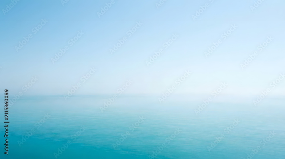 Fototapeta premium Ocean horizon meets a clear blue sky in a serene and expansive view of calm water during the day.