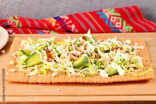 Chicharron preparado. Traditional Mexican cuisine served on wooden cutting board with vibrant napkin