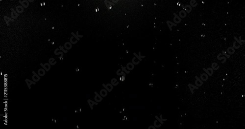 Ultra slow motion floating water droplets on a black background. Premium VFX overlay for cinematic compositing, motion graphics, title animations, trailers and professional visual effects.